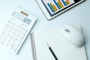 Financial tools with calculator, charts, and notebook representing Nucleus Accounting software for business management
