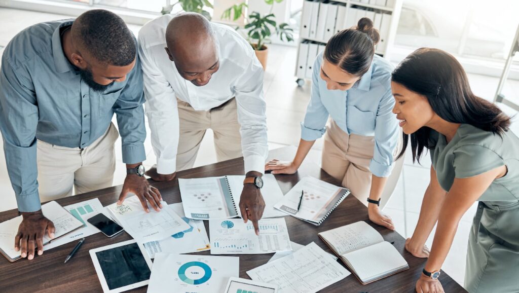 Business team reviewing analytics reports with digital tools for operational efficiency to support data-driven decision-making.