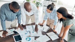 Business team reviewing analytics reports with digital tools for operational efficiency to support data-driven decision-making.