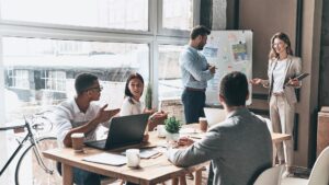 Team collaborating in office using Nucleus CRM to plan sales, improve service, and streamline customer management