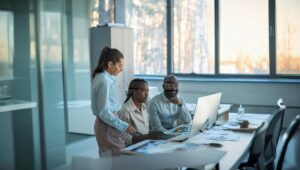 Sales team collaborating on computer using Nucleus CRM to manage leads and customer relationships.