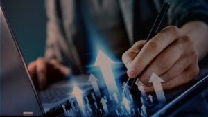 Business professional using laptop and tablet with growth arrows symbolizing profitability gains through Nucleus Service