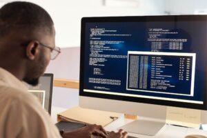 Professional using job costing software on a computer to ensure billing accuracy and streamline office automation processes.