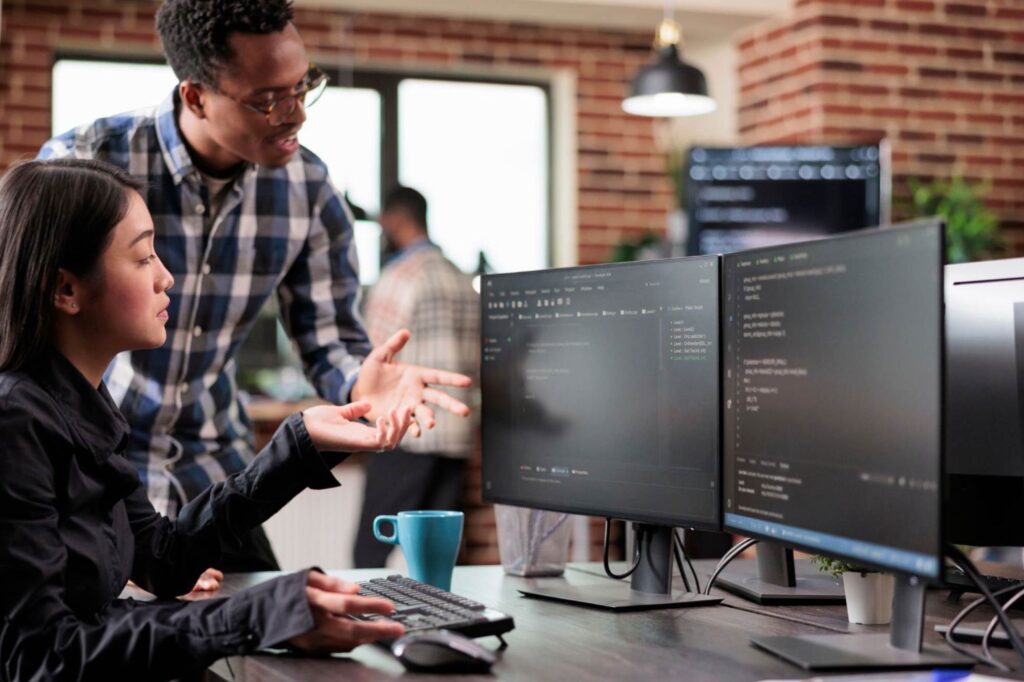 IT professionals collaborating on managed services software to improve security and eliminate data silos.