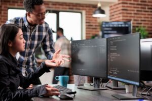 IT professionals collaborating on managed services software to improve security and eliminate data silos.