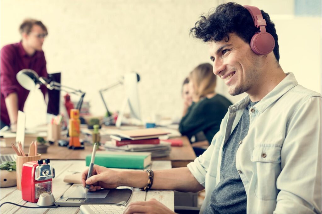 Team member using digital tools in a busy office, representing the shift from spreadsheets to field service management software