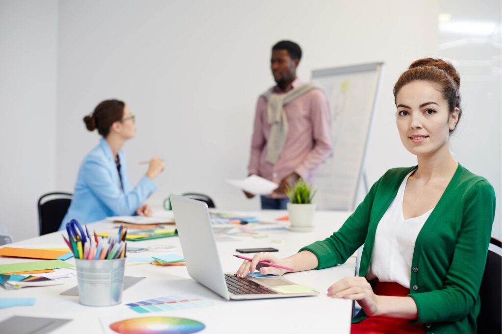 Team reviewing documents at a desk while using a contract management system for improved CCTV compliance.