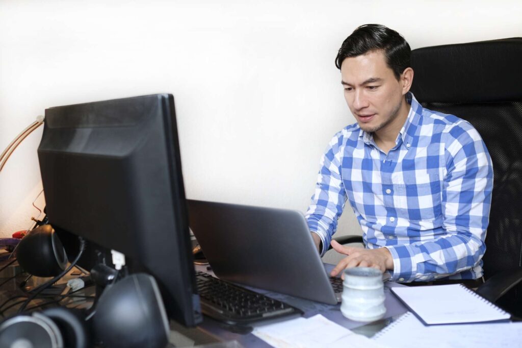 Office worker reviewing data on a computer, highlighting the need for spreadsheet alternatives