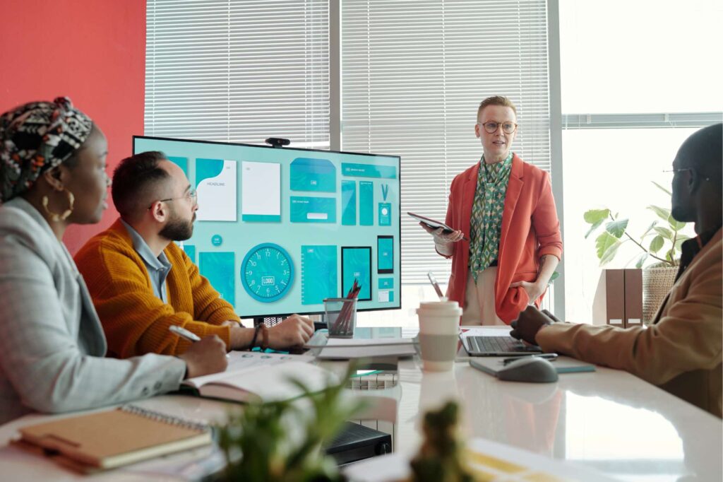 Team reviewing dashboards in a meeting using asset management software to improve visibility, decision-making, and operational control