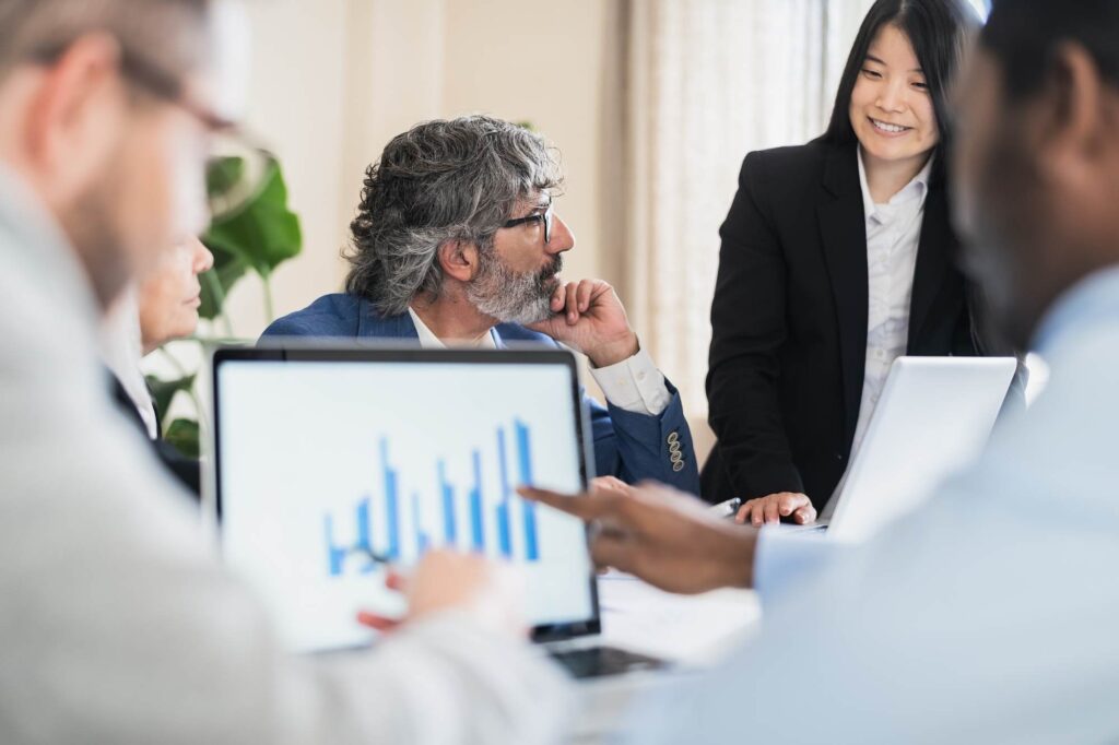 Leadership team reviewing performance data using ERP for facilities management companies to improve visibility, compliance, and operational control
