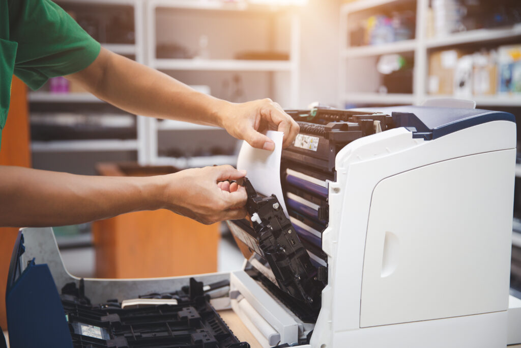 technician servicing a photocopier for meter reading