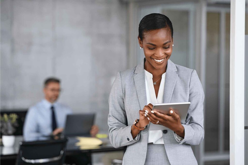 Businesswoman reviewing a contract management system on a tablet in a modern office